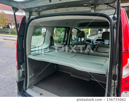Van interior shows storage space and seating arrangement ideal for camping or transporting items in a practical setting 136735062