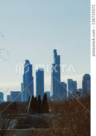 City skyline stretches across the horizon with tall buildings under a clear blue sky during daytime City skyline stretches across the horizon with tall buildings under a clear blue sky during daytime 136735072