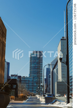 City street view with tall buildings and clear sky in urban area on a winter day City street view with tall buildings and clear sky in urban area on a winter day 136735146