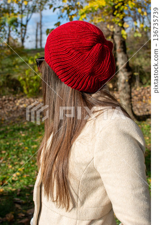 Woman in red knit beret in autumn park 136735739