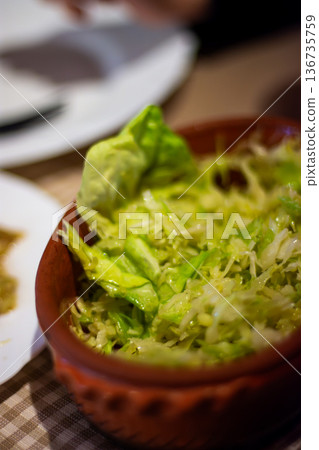 Fresh green salad in rustic bowl with shallow focus 136735759