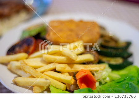 Fried fish fillet with french fries and salad on plate Fried fish fillet with french fries and salad on plate 136735760