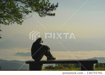 sunrise with man see moving of cloud and clear sky and layer of mountain sunrise with man see moving of cloud and clear sky and layer of mountain 136735791