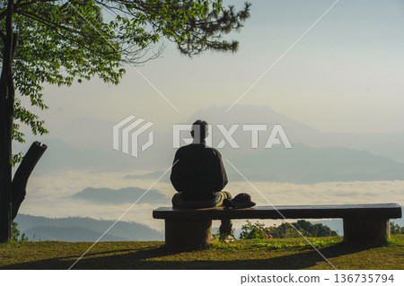 sunrise with man see moving of cloud and clear sky and layer of mountain sunrise with man see moving of cloud and clear sky and layer of mountain 136735794
