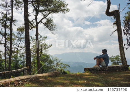 sunrise with man see moving of cloud and clear sky and layer of mountain sunrise with man see moving of cloud and clear sky and layer of mountain 136735798