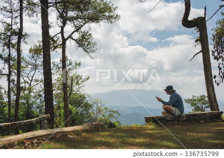 sunrise with man see moving of cloud and clear sky and layer of mountain sunrise with man see moving of cloud and clear sky and layer of mountain 136735799