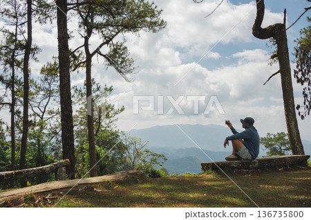 sunrise with man see moving of cloud and clear sky and layer of mountain sunrise with man see moving of cloud and clear sky and layer of mountain 136735800
