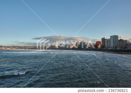 San Lorenzo Beach in Gijon, Asturias, with the city skyline in the background 136736821