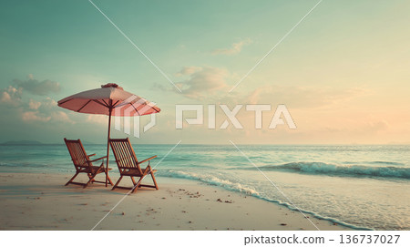 Two wooden deck chairs under umbrella on beach 136737027