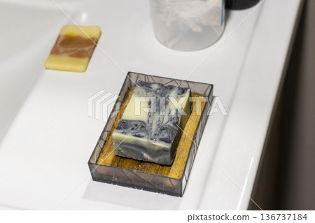The soap bar holder with handmade bar soap containing activated charcoal, neem oil, hemp oil, and shea butter. The soap bar holder with handmade bar soap containing activated charcoal, neem oil, hemp oil, and shea butter. 136737184