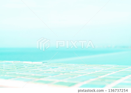 Advertisement for your cosmetics product on the background of the blue sky near the pool Advertisement for your cosmetics product on the background of the blue sky near the pool 136737254