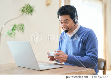 Senior Asian man enjoying PC games 136737666
