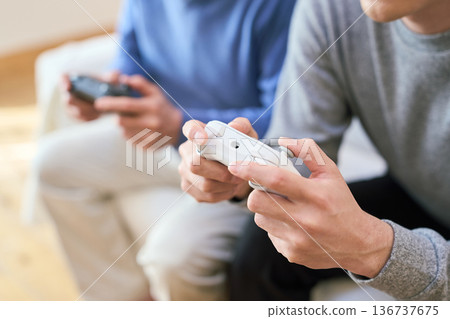 Asian family enjoying games together Asian family enjoying games together 136737675