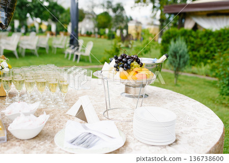 Fruit Plate And Champagne Glasses On Outdoor Reception Table Fruit Plate And Champagne Glasses On Outdoor Reception Table 136738600