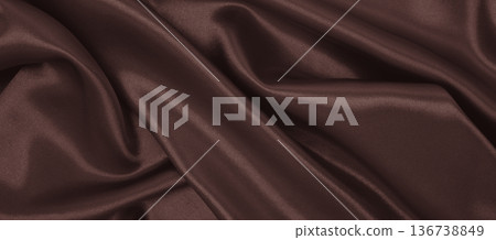 Smooth elegant dark brown silk or satin luxury cloth texture as abstract background. Luxurious background design. In Sepia toned. Retro style Smooth elegant dark brown silk or satin luxury cloth texture as abstract background. Luxurious background design. In Sepia toned. Retro style 136738849