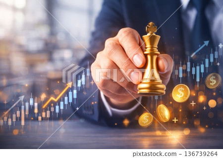 Businessman holding golden king chess piece symbolizing leadership and financial growth Businessman holding golden king chess piece symbolizing leadership and financial growth 136739264
