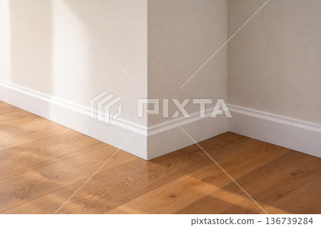Clean modern room corner with white baseboard and wooden floor interior detail Clean modern room corner with white baseboard and wooden floor interior detail 136739284