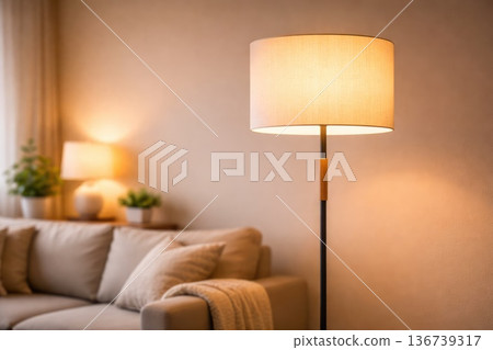Modern floor lamp glowing in cozy living room interior with warm ambient lighting 136739317