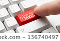 Finger Pressing Red Key with Time for Taxes Text on Computer Keyboard 136740497