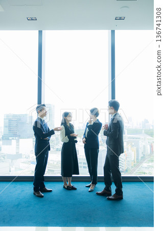 Business people standing and talking 136741308