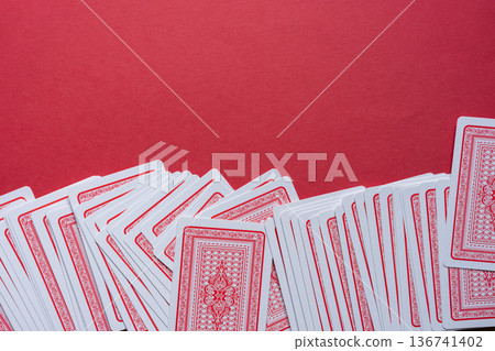 Playing cards lined up on a red background Playing cards lined up on a red background 136741402