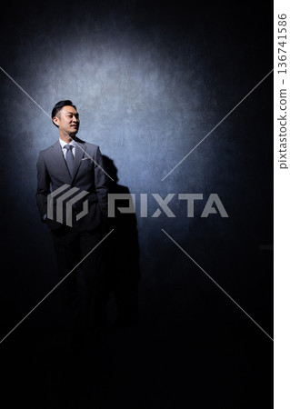 Businessman on a dark background 136741586