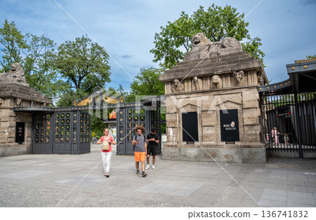 Berlin, germany, august 14,2023. Tourists entering berlin zoo through the historic lion gate or lowentor, a famous landmark and architectural entrance Berlin, germany, august 14,2023. Tourists entering berlin zoo through the historic lion gate or lowentor, a famous landmark and architectural entrance 136741832