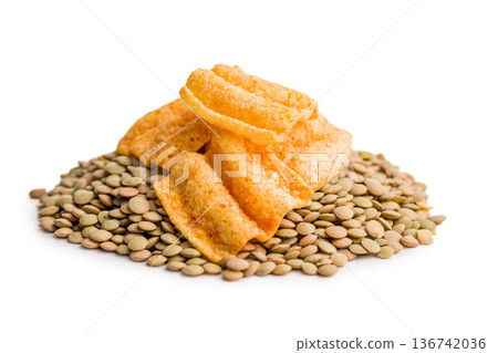 Crispy lentil chips isolated on white background. Crispy lentil chips isolated on white background. 136742036