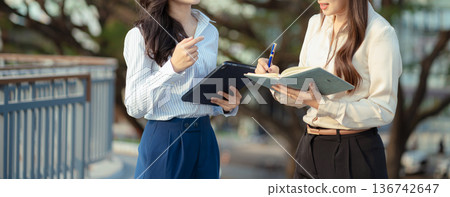 Business team talking outside office, with discussing update tasks with milestones progress planning and professional investor working new start up project. 136742647