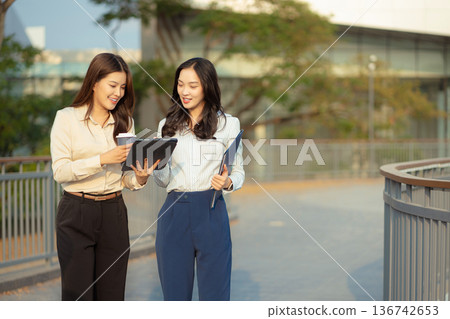 Business team walking and talking on street in city Outside Office and drinking coffee together, partners, teamwork. Business team walking and talking on street in city Outside Office and drinking coffee together, partners, teamwork. 136742653