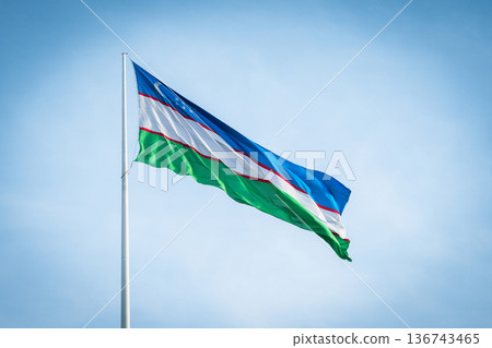 Uzbekistan Flag Waving in Blue Sky, National Symbol of Uzbekistan Uzbekistan Flag Waving in Blue Sky, National Symbol of Uzbekistan 136743465