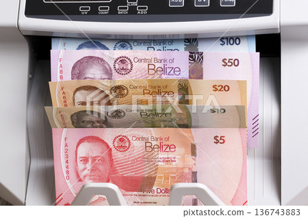 Belizean Dollars in the counting machine Belizean Dollars in the counting machine 136743883