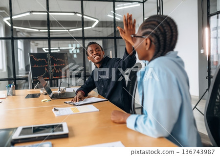 Making high five, success. Business people are working in the office Making high five, success. Business people are working in the office 136743987