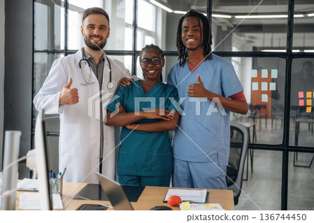 Standing and posing. Doctors are working in the office Standing and posing. Doctors are working in the office 136744450