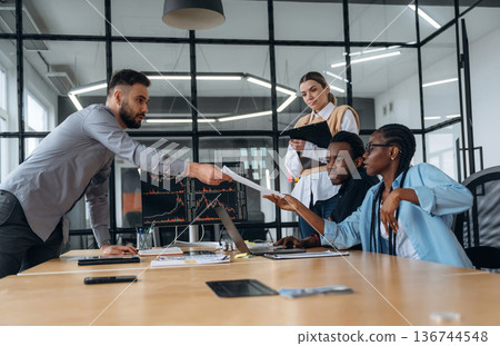 In conference room by the table. Business people are working in the office 136744548