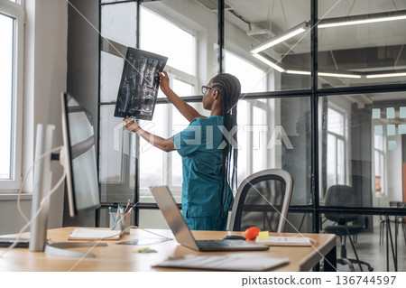 Female doctor in coat is in the office clinic 136744597