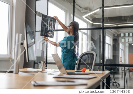 Female doctor in coat is in the office clinic 136744598