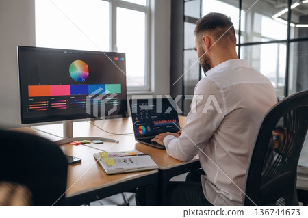 Working by using laptop. Designer is in the office 136744673