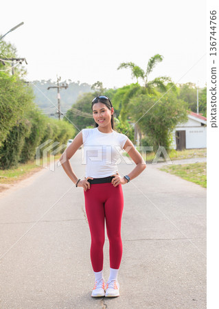Fit Asian Woman in Sportswear Standing Outdoors in Street Ready for Jogging Fit Asian Woman in Sportswear Standing Outdoors in Street Ready for Jogging 136744766
