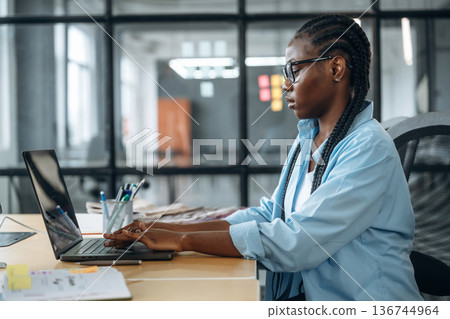 Working by using laptop. Designer is in the office Working by using laptop. Designer is in the office 136744964