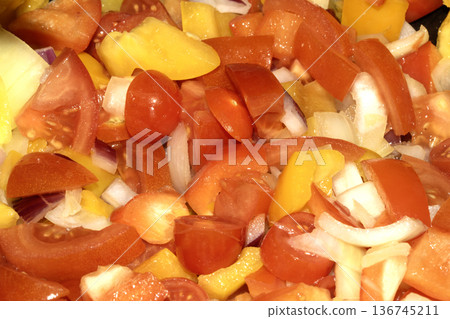 Close up of mixed fried vegetables chopped tomatoes, onions and peppers frying Close up of mixed fried vegetables chopped tomatoes, onions and peppers frying 136745211