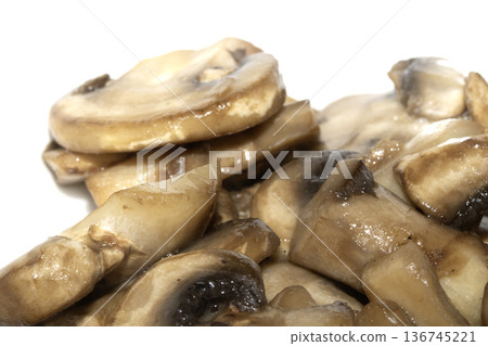 Close up of fried chopped sliced mushrooms on white background Close up of fried chopped sliced mushrooms on white background 136745221