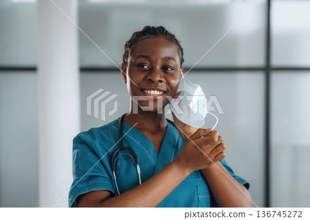 Female doctor is indoors in modern room Female doctor is indoors in modern room 136745272