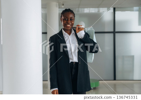 Businesswoman in formal clothes is in the modern room Businesswoman in formal clothes is in the modern room 136745331