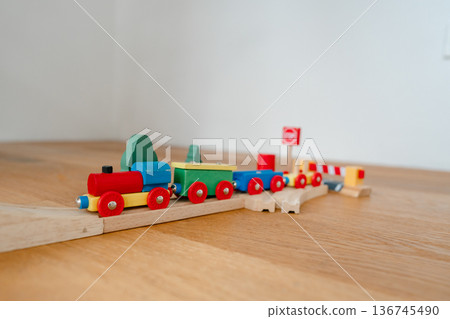 Wooden railway toy set displayed in modern apartment interior. Clean product-style image suitable for catalog, online shop or advertising campaign. 136745490