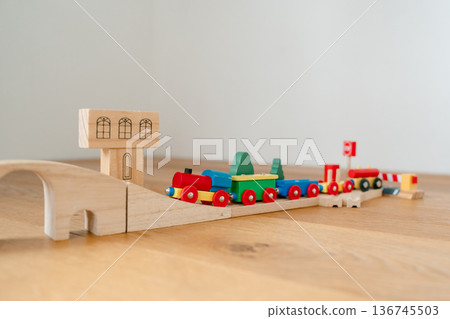 Wooden railway toy set displayed in modern apartment interior. Clean product-style image suitable for catalog, online shop or advertising campaign. Wooden railway toy set displayed in modern apartment interior. Clean product-style image suitable for catalog, online shop or advertising campaign. 136745503