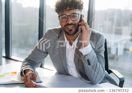 Making a deal, phone call. Businessman is sitting in the office 136745552