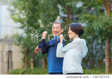 Men and women exercising 136745579