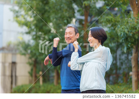 Men and women exercising 136745582