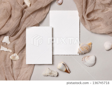 Blank paper cards mockup with seashells on beige stone, coastal wedding stationery, copy space Blank paper cards mockup with seashells on beige stone, coastal wedding stationery, copy space 136745718